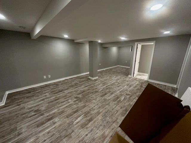 Finished basement with new floors and recessed lighting
